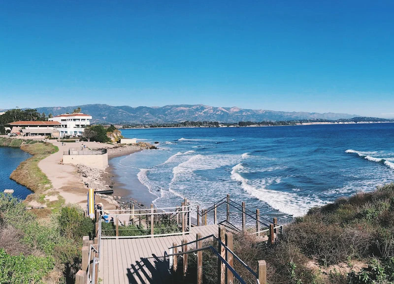Stunning coastal view of Santa Barbara surf spots and mountain backdrop. Perfect for surfing lessons and beach days.