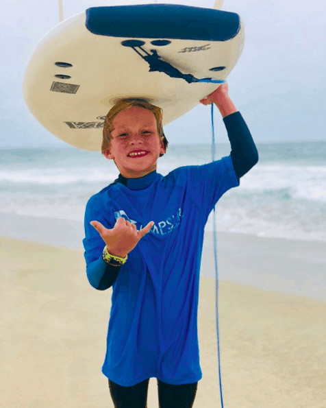 kid with surfboard